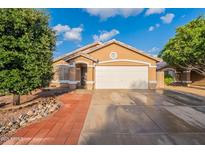 Charming single-story home with a two-car garage, desert landscaping, and a welcoming facade at 425 S 93Rd Pl, Mesa, AZ 85208