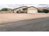 Charming single-story home featuring desert landscaping, attached garage, and quaint curb appeal at 5122 E Shadow Ln, San Tan Valley, AZ 85140