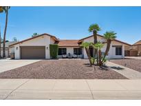 Charming single-story home featuring desert landscaping, a tile roof, and inviting curb appeal at 5415 E Juniper Ave, Scottsdale, AZ 85254