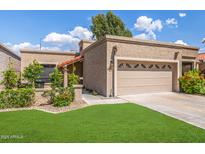Charming home with well-maintained lawn and a two-car garage at 6597 N 79Th Pl, Scottsdale, AZ 85250