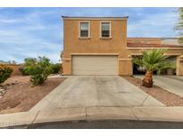 Inviting two-story townhome featuring attached two-car garage and well-maintained desert landscaping at 7064 W Lincoln St, Peoria, AZ 85345