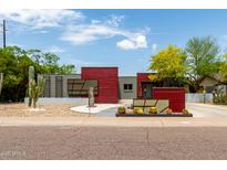 Unique home boasts drought-tolerant landscaping, red siding accents, and plenty of curb appeal at 8314 E Vista Dr, Scottsdale, AZ 85250
