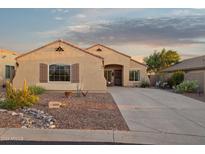Charming single-story home featuring desert landscaping, a concrete driveway, and a cozy front porch at 10109 E Trailhead Ct, Gold Canyon, AZ 85118