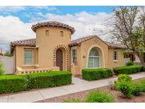Charming stucco home featuring a turret entrance, tile roof, and manicured landscaping at 1162 S Agnes Ln, Gilbert, AZ 85296