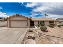 Charming single-story home featuring desert landscaping, a two-car garage, and a welcoming front entrance at 1332 E Redfield Rd, Tempe, AZ 85283