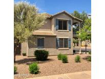 Two-story home showcasing blue shutters, neutral stucco, and low-maintenance desert landscaping at 1689 E Elgin St, Gilbert, AZ 85295