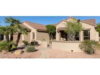 Charming single-story home featuring desert landscaping, tiled roof, and inviting gated entrance at 17911 N Adobe Mesa Ct, Surprise, AZ 85374