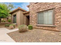 Charming stone and stucco home with manicured landscaping at 2042 W Mark Ln, Phoenix, AZ 85085