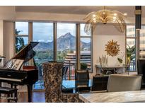 Bright dining room with elegant lighting fixture and mountain views at 2211 E Camelback Rd # 902, Phoenix, AZ 85016