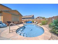 Backyard pool featuring stone surround, steps, and lovely desert landscaping at 23773 W Hammond Ln, Buckeye, AZ 85326