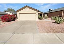 Well-maintained single-story home featuring a desert landscape, spacious driveway, and an attached two-car garage at 2906 W Irma Ln, Phoenix, AZ 85027