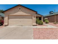 Beige single-story home featuring a two-car garage, desert landscaping, and a new roof at 2906 W Irma Ln, Phoenix, AZ 85027