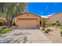 Charming single-story home features a two-car garage and professionally landscaped front yard at 30266 N Royal Oak Way, San Tan Valley, AZ 85143