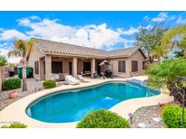 Inviting pool area with covered patio, lounge chairs, and lush landscaping perfect for outdoor relaxation and entertaining at 3519 E Bridgeport Pkwy, Gilbert, AZ 85295