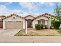Charming single-story home featuring a well-manicured lawn and a two-car garage with a tile roof at 510 W Amoroso Dr, Gilbert, AZ 85233