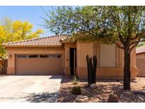 Charming single-story home with desert landscaping and a two-car garage at 5401 S Dove Holw, Buckeye, AZ 85326