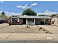 Charming single-story home with a covered carport and low maintenance desert landscaping at 8402 N 105Th Ln, Peoria, AZ 85345