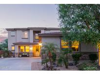 Inviting two-story home featuring a charming front porch, desert landscaping, and a warm, welcoming ambiance at 9231 W Bent Tree Dr, Peoria, AZ 85383