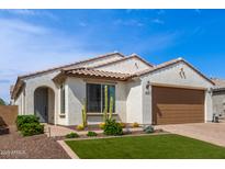Charming home featuring a well-manicured lawn, desert landscaping, and a tile roof at 9570 W Whispering Wind Dr, Peoria, AZ 85383