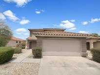 Charming two-story home featuring a tile roof and a spacious two-car garage at 1078 E Poncho Ln, San Tan Valley, AZ 85143
