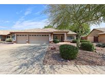Charming single-story home featuring a three-car garage and desert landscaping at 11034 W Sierra Pinta Dr, Peoria, AZ 85373