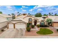 Charming home showcasing a well-manicured front yard and an attached two-car garage with desert landscaping at 1146 W Sea Fog Dr, Gilbert, AZ 85233