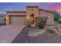 Charming single-Gathering home with a well-manicured front yard and a two-car garage at 1260 E Sweet Citrus Dr, Queen Creek, AZ 85140