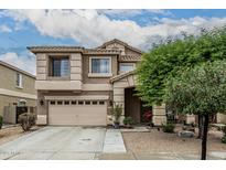 Charming two-story home featuring a well-manicured lawn, a two-car garage, and a welcoming entryway at 14318 N 142Nd Ln, Surprise, AZ 85379