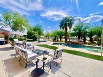 Stunning backyard oasis with a large pool, lush landscaping, and comfortable patio seating for outdoor entertaining at 15602 N 37Th St, Phoenix, AZ 85032