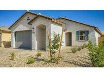 Charming single-story home featuring stucco siding, gray garage door, and low-maintenance desert landscaping at 16754 W Alameda Rd, Surprise, AZ 85387