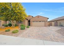 Beautiful single-story home with a well-manicured front yard and a charming brick driveway at 3359 E Penedes Dr, Gilbert, AZ 85298