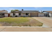 Charming single-story home featuring a well-maintained lawn and an attached two-car garage at 3709 W Grovers Ave, Glendale, AZ 85308