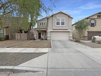 Inviting two-story home with a wide driveway, attached garage, and well-maintained lawn at 4005 W Carter Rd, Phoenix, AZ 85041