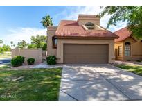 Inviting front exterior featuring desert landscaping, a two-car garage, and a red-tiled roof at 4653 W Dublin St, Chandler, AZ 85226