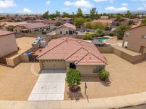 Charming single-story home featuring a red tile roof, low maintenance landscaping, and a private backyard pool at 4728 N 92Nd Ave, Phoenix, AZ 85037