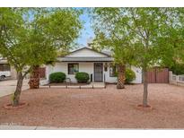 Charming home featuring a well-maintained front yard with mature trees at 5025 N 20Th Ave, Phoenix, AZ 85015