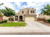 Charming two-story home with a well-manicured lawn and a spacious two-car garage at 7342 S Debra Dr, Gilbert, AZ 85298