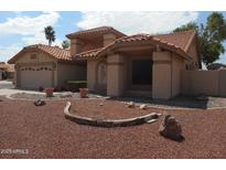 Charming home featuring a tile roof, desert landscaping, and inviting curb appeal at 9203 W Behrend Dr, Peoria, AZ 85382