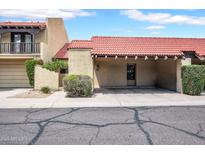 Charming townhome with a red tile roof, covered parking, and desert landscaping at 10235 N 31St St # 15, Phoenix, AZ 85028