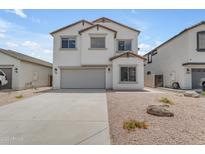 Two-story home with a two-car garage, neutral paint, rock landscaping and concrete driveway at 1237 W Agrarian Hills Dr, San Tan Valley, AZ 85143