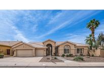 Charming single-story home with desert landscaping, inviting front walkway, and a well-manicured lawn at 14033 S 31St St, Phoenix, AZ 85048