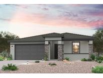 Charming single-story home featuring stone accents, a two-car garage, and a beautifully xeriscaped front yard at 17972 W Camino De Oro --, Surprise, AZ 85387