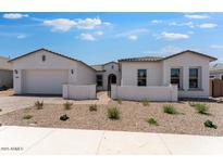 Charming single-story home featuring a stucco exterior, desert landscaping, and a two-car garage at 18883 E Celtic Manor Dr, Queen Creek, AZ 85142