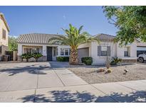 Charming single-story home featuring a well-maintained front yard and a spacious driveway at 19323 E Canary Way, Queen Creek, AZ 85142