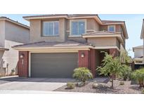 Two-story home featuring an attached garage, brick accents, desert landscaping and neutral paint scheme at 22023 N 28Th Pl, Phoenix, AZ 85050
