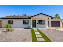 Charming home featuring a modern design, gravel landscaping, and a walkway with artificial turf at 2926 E Corrine Dr, Phoenix, AZ 85032