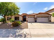 Charming home featuring a tile roof, desert landscaping, and a spacious three-car garage at 29506 N 21St Ave, Phoenix, AZ 85085