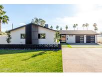 Charming single-story home with a modern design, manicured lawn and spacious driveway at 3502 N Rose Circle Dr, Scottsdale, AZ 85251