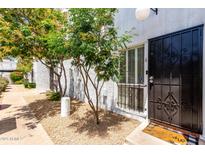 Charming front entrance features a secure black metal gate and a well maintained pebble ground cover at 6348 N 7Th Ave # 6, Phoenix, AZ 85013