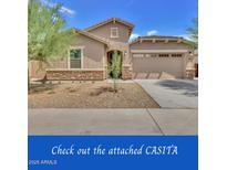 Charming single-story home featuring a two-car garage and a low-maintenance front yard at 9630 W Atlantis Way, Tolleson, AZ 85353